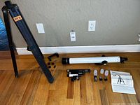 Overview of telescope tube, tripod and accessories on floor