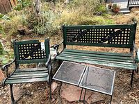 Bench, chair and two tables grouped outdoors