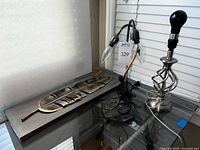 Overall lot showing feather sculpture and two different lamps