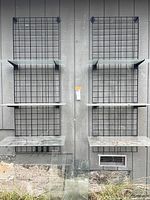 Full view of both wire grid panels with six glass shelves and extra glass panes leaning below