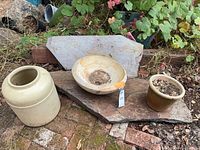Group shot showing two slate slabs, stoneware crock, stone bowl planter and brown pottery planter