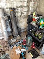 Overview showing landscape fabric rolls, pruning shears, irrigation kit, bird feeders, plant food and moss bags