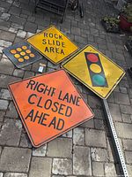 All four signs and perforated pole laid out together