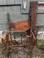 Group shot showing Singer base, tractor seat, crosscut saw and digging bar