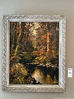 Framed autumn landscape painting on wall