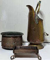 Group shot showing brass ewer, copper planter, copper tray