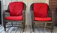 Front view of both wicker armchairs with red cushions
