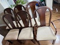 six matching wood dining chairs, two with arms