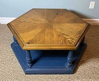 Top view of hexagonal coffee table showing oak veneer starburst pattern and painted base