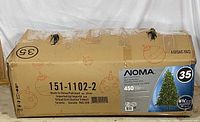 Front view of worn NOMA box showing product and model information