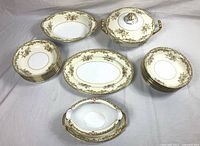 Full lot showing tureen, serving bowl, platter, gravy boat and two stacks of soup bowls