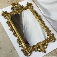 Front view of mirror in portrait orientation showing full ornate frame and glass