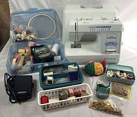 Overall lot showing sewing machine, pedal, organizers and notions