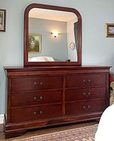 Dresser with attached framed mirror front view
