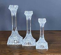 Front view of three graduated WMF crystal candle holders
