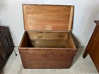 Open wooden blanket box showing interior wood surfaces