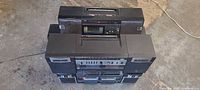 Four boomboxes stacked showing overall lot