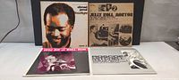 Group shot of four jazz LPs showing front jackets
