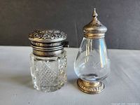 Front view of both items showing size, glass patterns, sterling mounts and lids