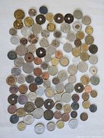 Full spread of assorted foreign coins, different metals and sizes