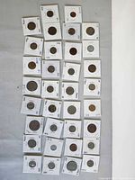 Column of cardboard-flipped coins displayed on fabric
