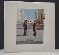 Front of outer sleeve with burning man handshake artwork