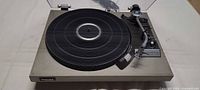 Full view of Technics SL-23 turntable with dust cover open, platter and tonearm visible