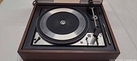 Full view of Dual 1218 turntable in wood plinth with tonearm and platter