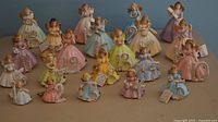 All 21 Josef Originals birthday angel figurines arranged front view