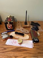 Overall lot showing shoe shine box, cobbler stand, brushes, shoehorns, polish and accessories