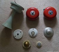 Group shot of all eight fire alarm devices on carpet