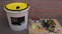 Bucket, some lures, jig heads visible