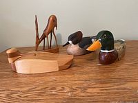 Group shot of all four carved wooden items