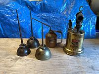 Group shot: Butler blow torch and four pump oilers on table