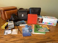 Overall lot: bags, flashbulbs, flash unit, accessories and literature