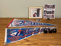 Overall lot view showing pennants, rings, framed golf print, card, figurines and tees