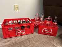 Full view of Pop Shoppe crate and two carriers with bottles