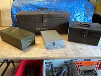 All four metal boxes on table