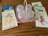 Top view of full lot showing jars in basket surrounded by five pamphlets