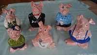 Front view of all six Wade NatWest pig banks