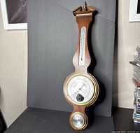 Front view of entire wood weather station showing all three instruments