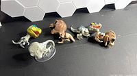 Six Funko Pop Jurassic World dinosaur figures arranged on tabletop