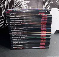 Stack of Singer Sewing Reference Library books showing titles
