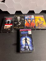 Five sealed VHS tapes visible; front tape The Abyss, back row Panic Room, A Civil Action, Antitrust, The Marksman