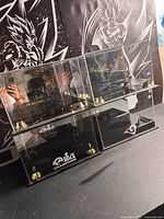 Four acrylic football display cases stacked two by two