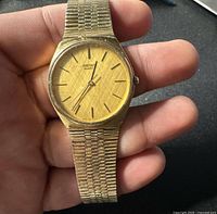 Front view showing gold-tone dial, hands, markers, and Seiko Quartz branding