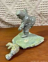 Overall view of soapstone fisherman on base with fish detached