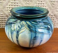 Front view of round blue-teal crystalline glaze vase