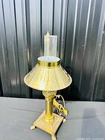 Full view of brass lamp with shade and chimney