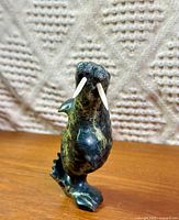 Front view of entire soapstone walrus sculpture showing tusks and surface finish